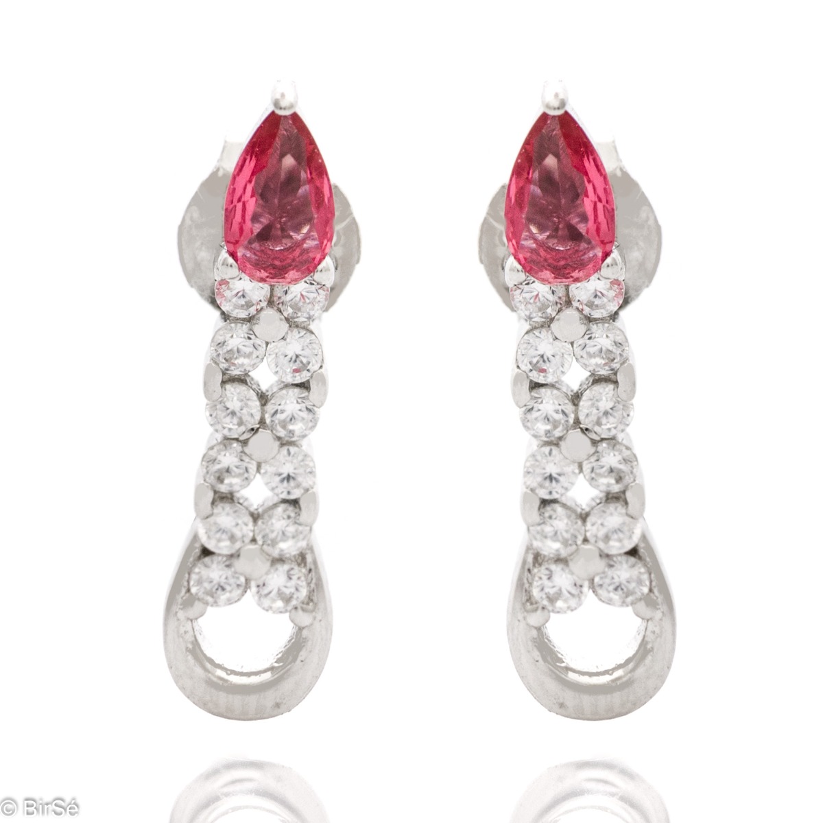 Elegant women's earrings made of soft rhodium-plated silver. A ruby-colored drop zircon is the main accent in the jewelry, in the company of more sparkling zircons. Pin fastening is convenient and practical.