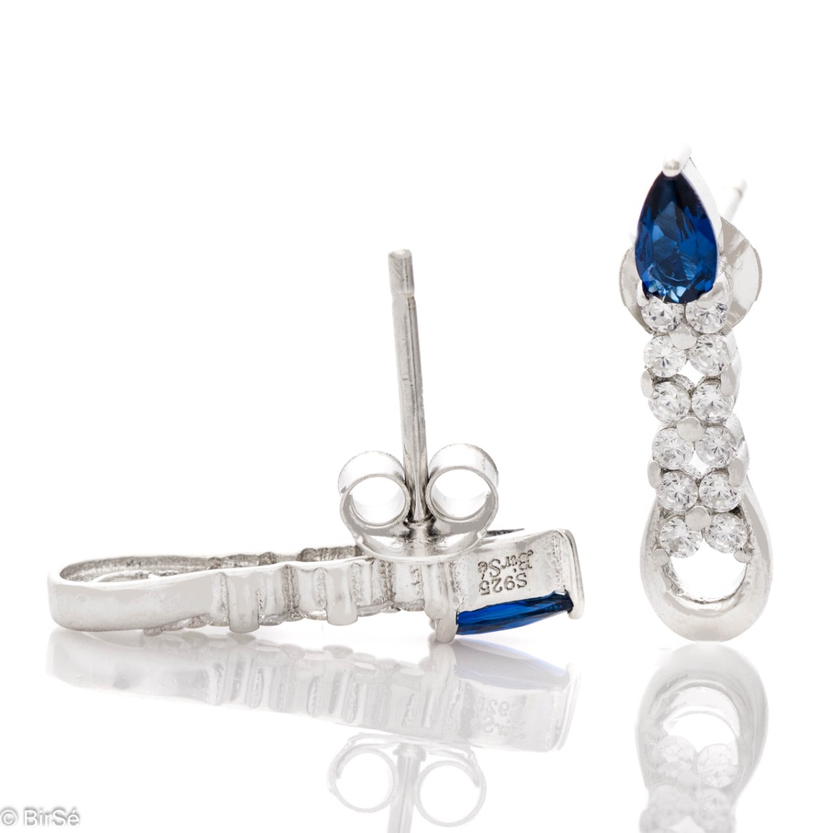 Elegant women's earrings made of soft rhodium-plated silver. A colored sapphire drop zircon is the main accent in the jewelry, in the company of more sparkling zircons. Pin fastening is convenient and practical.