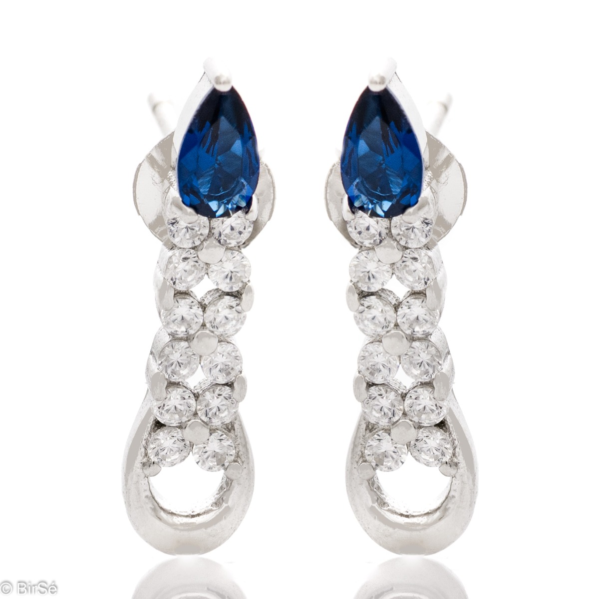 Elegant women's earrings made of soft rhodium-plated silver. A colored sapphire drop zircon is the main accent in the jewelry, in the company of more sparkling zircons. Pin fastening is convenient and practical.