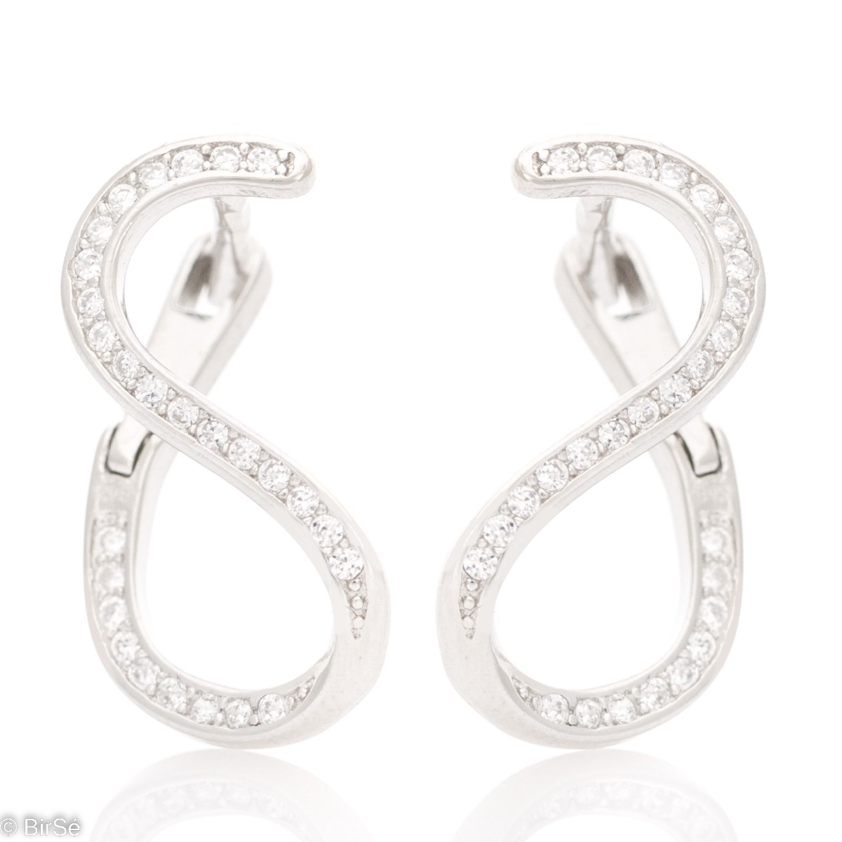 Charming earrings with a modern design and elegant style in rhodium silver. The shape resembles a figure of eight, and with the glittering presence of zircons, the earrings acquire even more charm and attract the eye.