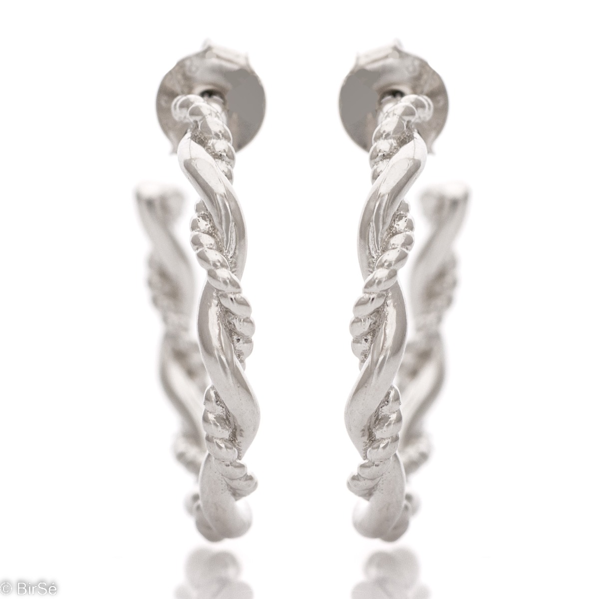 Captivating design of silver hoop earrings with pin fastening. The design includes twisted silver elements with different looks, but together forming an exquisite piece of jewelry.