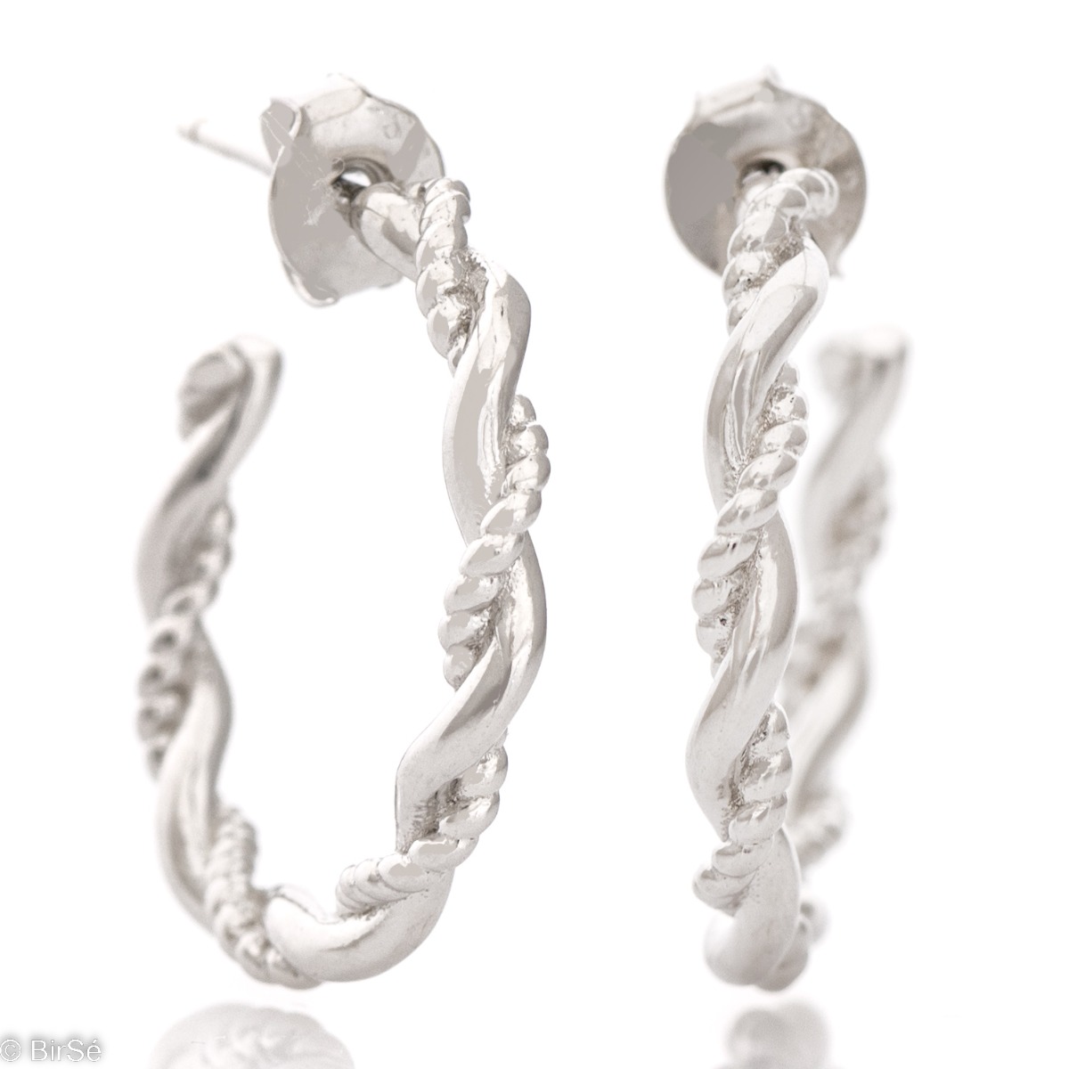 Captivating design of silver hoop earrings with pin fastening. The design includes twisted silver elements with different looks, but together forming an exquisite piece of jewelry.