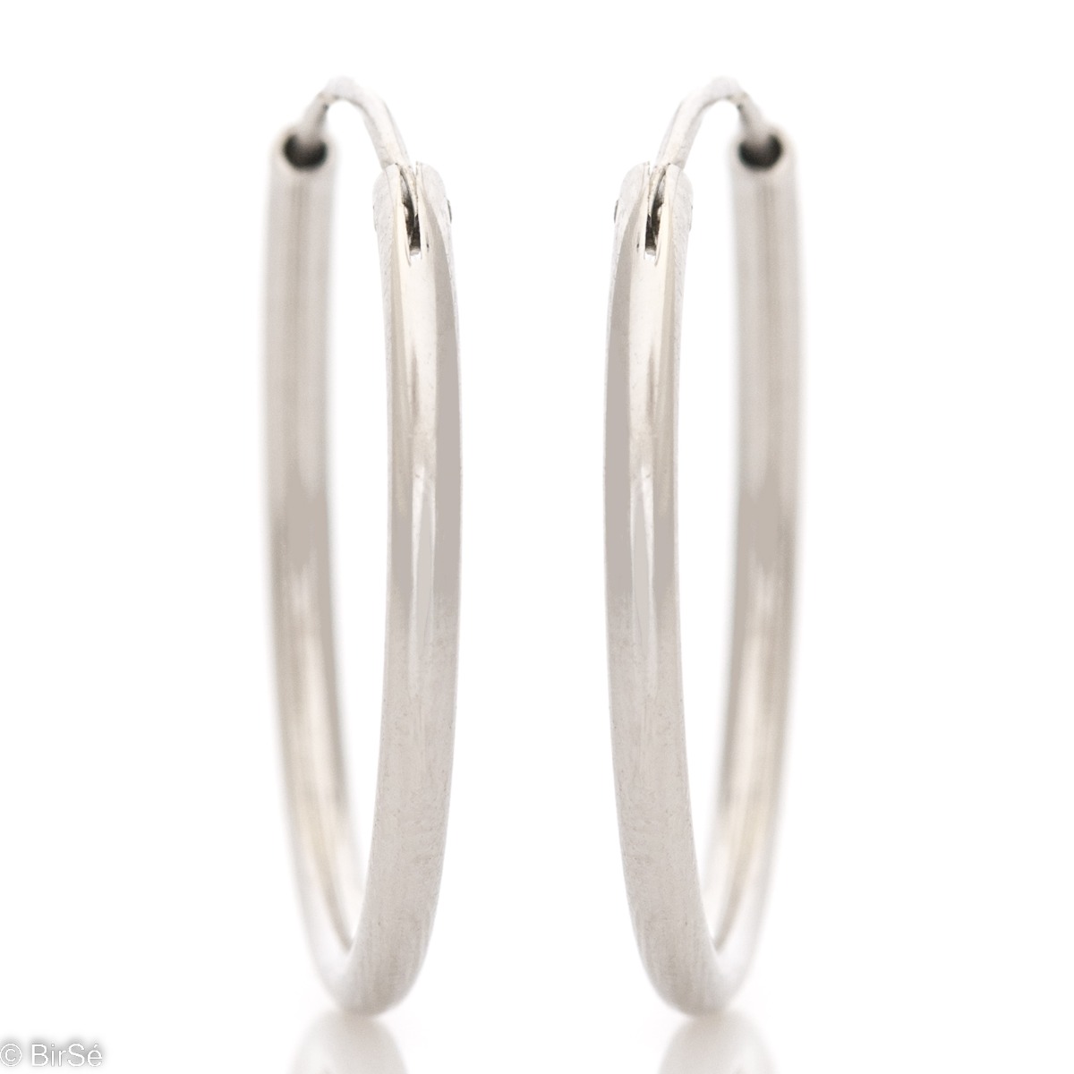 Classic design of women's earrings - rings of elegant rhodium-plated silver. The earrings are comfortable and practical for everyday use with an English clasp.