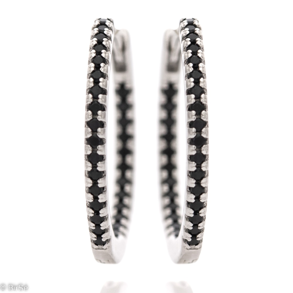 Elegantly made ladies' earrings - rhodium-plated silver rings with a spectacular design. The participation of onyx stones in combination with silver gives charm and charm to the jewelry. The earrings are comfortable and practical for everyday use with an 