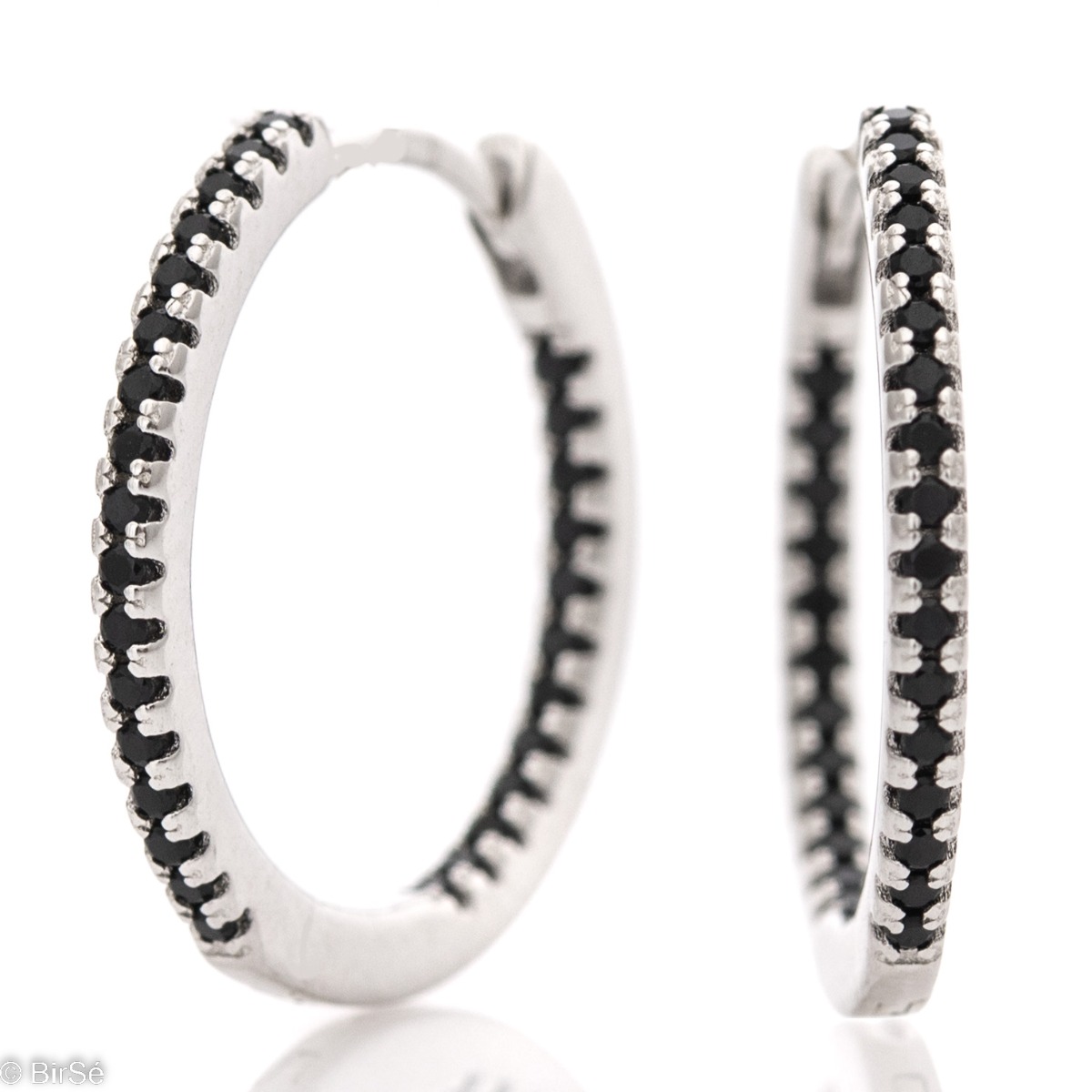 Elegantly made ladies' earrings - rhodium-plated silver rings with a spectacular design. The participation of onyx stones in combination with silver gives charm and charm to the jewelry. The earrings are comfortable and practical for everyday use with an 