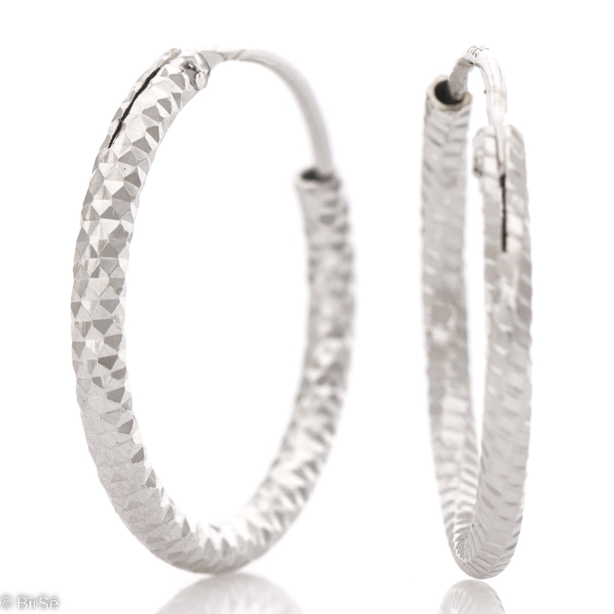 Exquisite workmanship of women's earrings - rings of elegant rhodium-plated silver with a diamond effect. The earrings are comfortable and practical for everyday use with an English clasp.