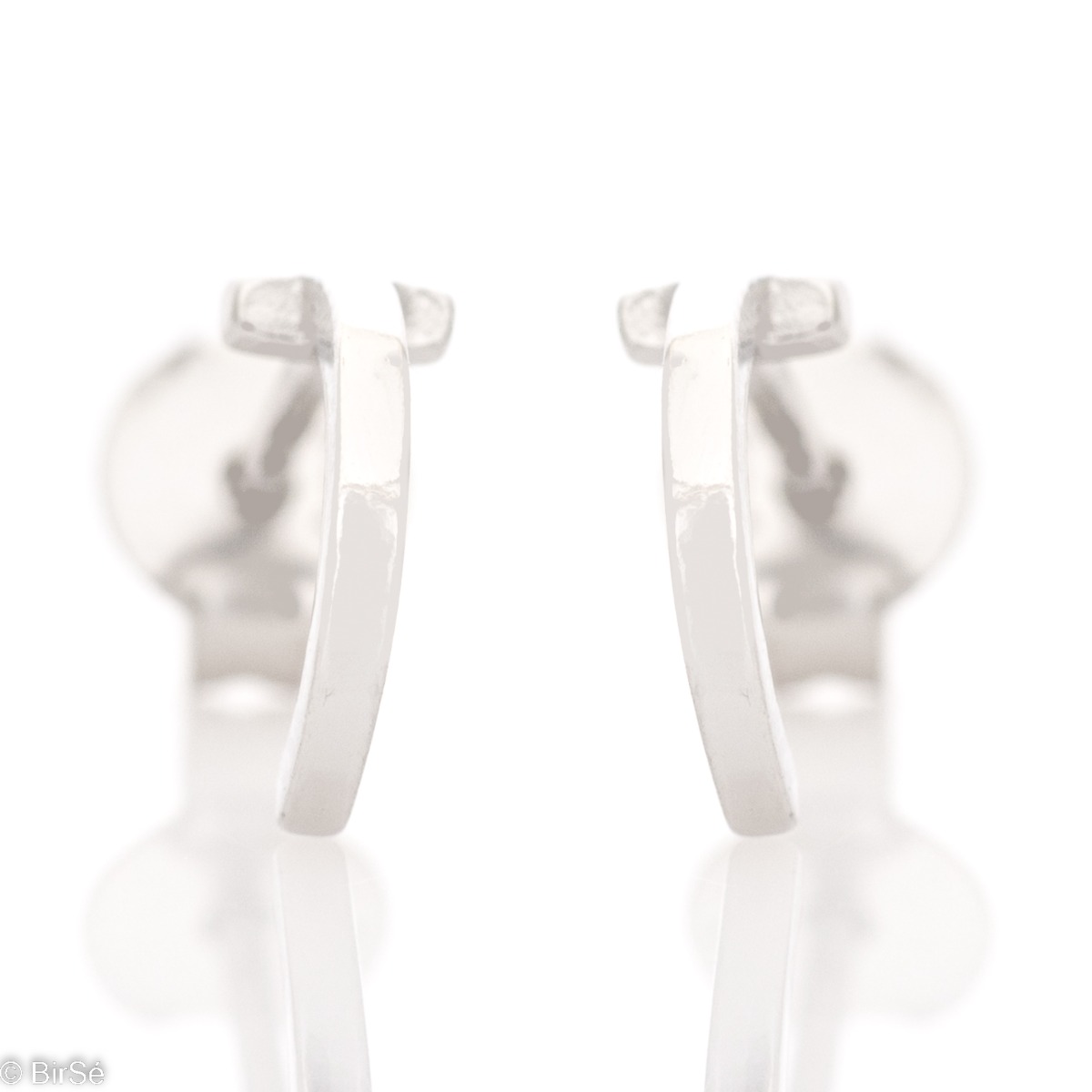 Simple earrings made with an elegant rhodium silver element design in the shape of a small arc. The fastening is with a pin - secure and preferred by the ladies. They can be worn as a second earring.