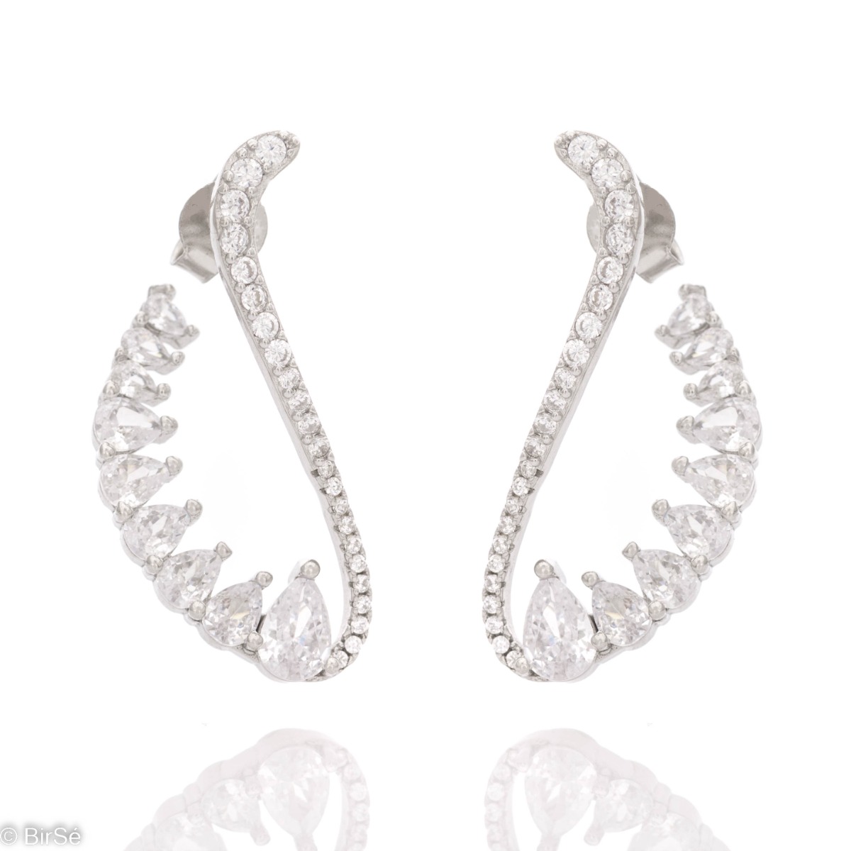 Exquisite workmanship of ladies' earrings made of rhodium silver. The stylish design is enhanced by the dazzling presence of zircons, of different shapes and sizes.