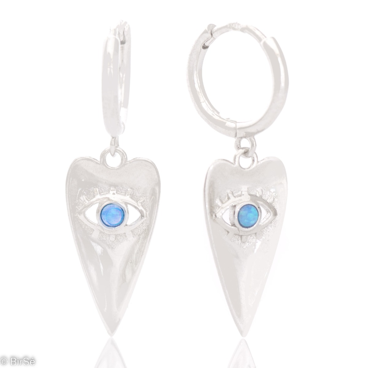 Spectacular rhodium silver earrings with a mystical look. An elongated heart-shaped tile cozily houses the all-seeing eye of Ra, decorated with fine turquoise.