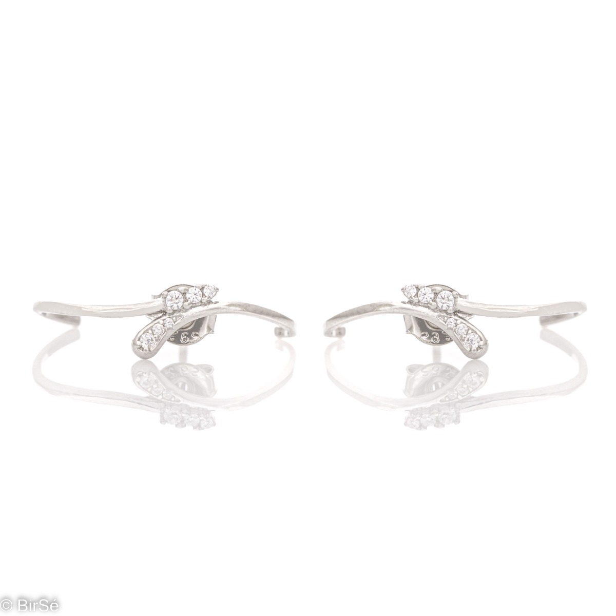 Non-standard model of silver earrings with pin fastening. Crafted from fine rhodium silver and embellished with zircons, the delicate earrings are a beautiful gift for stylish ladies.