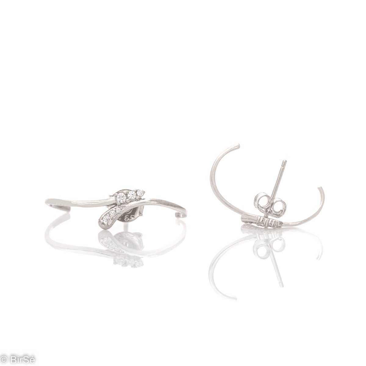 Non-standard model of silver earrings with pin fastening. Crafted from fine rhodium silver and embellished with zircons, the delicate earrings are a beautiful gift for stylish ladies.