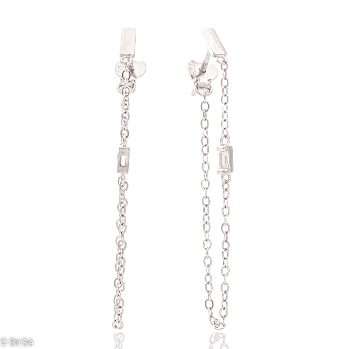 A simple model of women's dangling earrings with an elegant design, completely formed by combining a classic rhodium silver chain with a sparkling zircon. The fastening is with a pin - comfortable and practical.