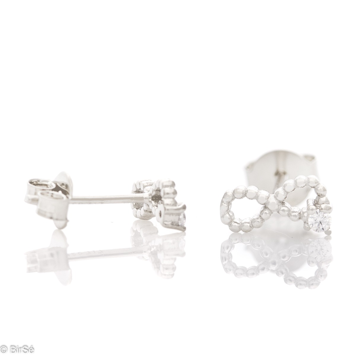 Charming women's earrings, exquisitely crafted through fine silver elements and the glamorous participation of a small zircon. The fastening is with a pin. Earrings are a beautiful proposal for a gift to a beloved woman.