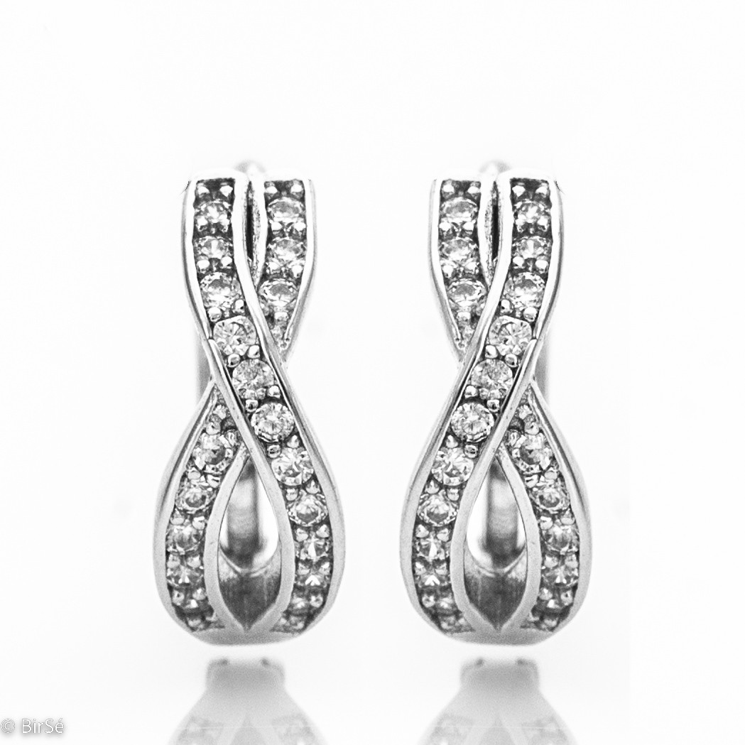 Delicate ladies' earrings made of rhodium-plated silver with a comfortable English clasp. The front side of the earrings is shaped like an exquisite infinity, carefully decorated with zircons. Suitable for ladies of all ages due to the secure fastening.