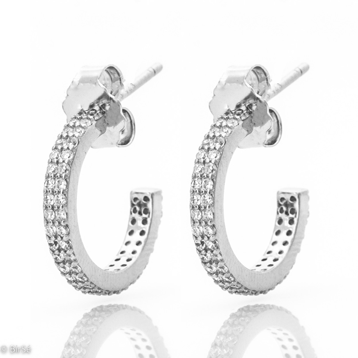 Spectacular women's earrings made of rhodium silver delicate half rings. The earrings are fully decorated with dazzling zircons, and the pin fastening makes them extremely comfortable.