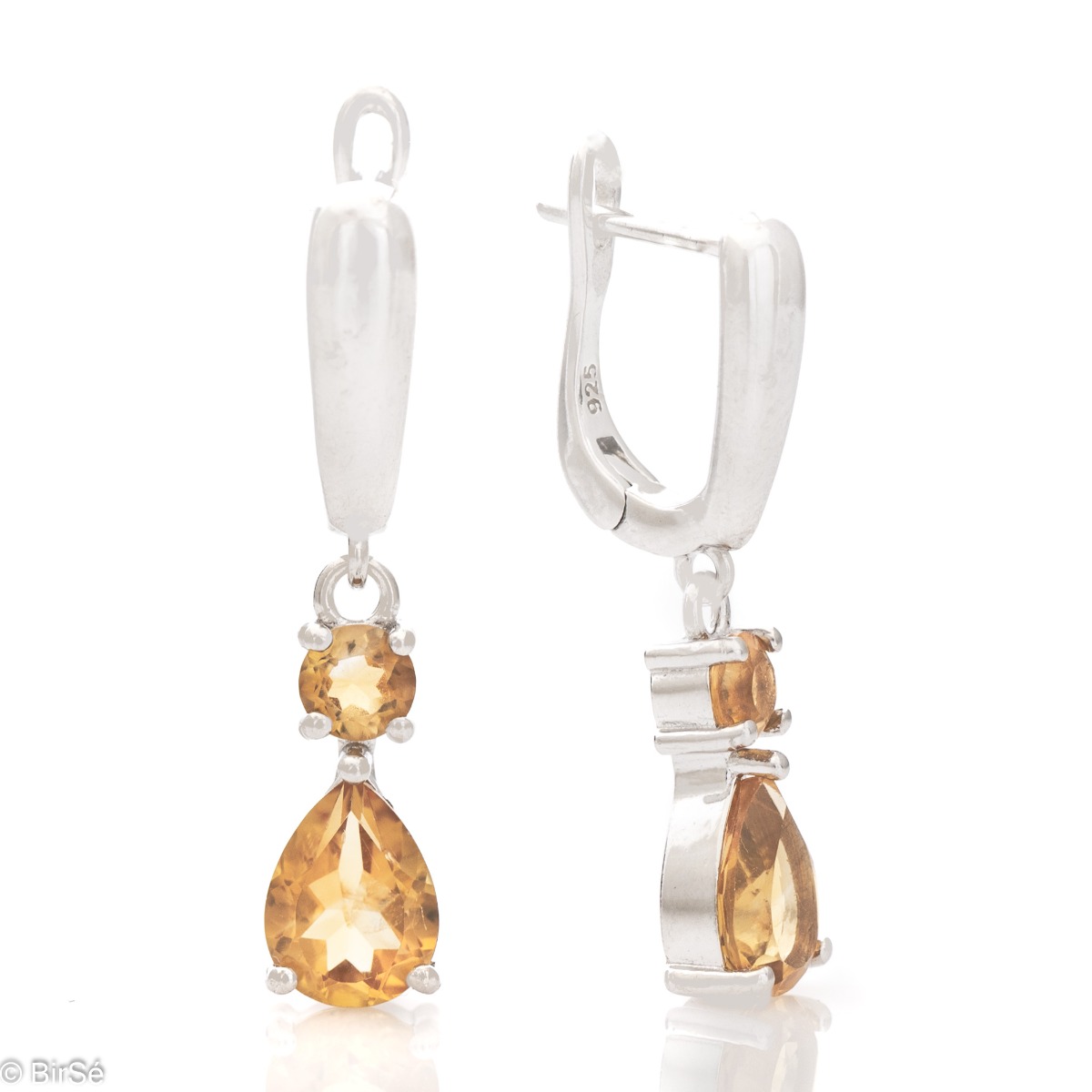 Fancy dangle earrings with English clasp. Finely cast silver and majestic natural drop-shaped citrine. Complete with a ring and pendant with the same elegant design.