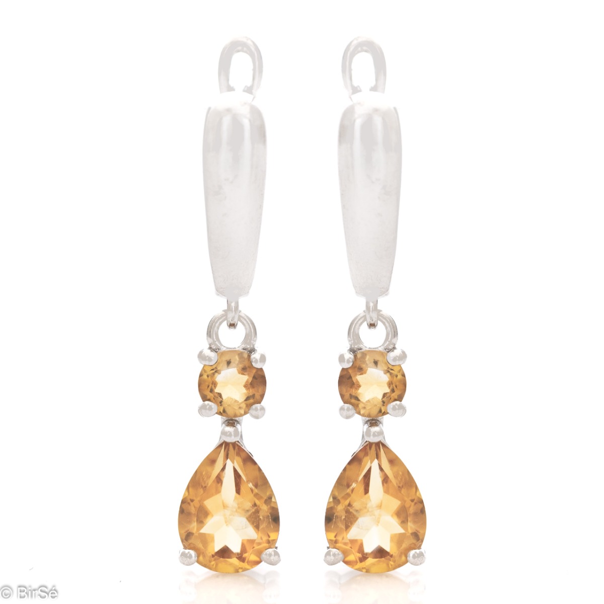 Fancy dangle earrings with English clasp. Finely cast silver and majestic natural drop-shaped citrine. Complete with a ring and pendant with the same elegant design.