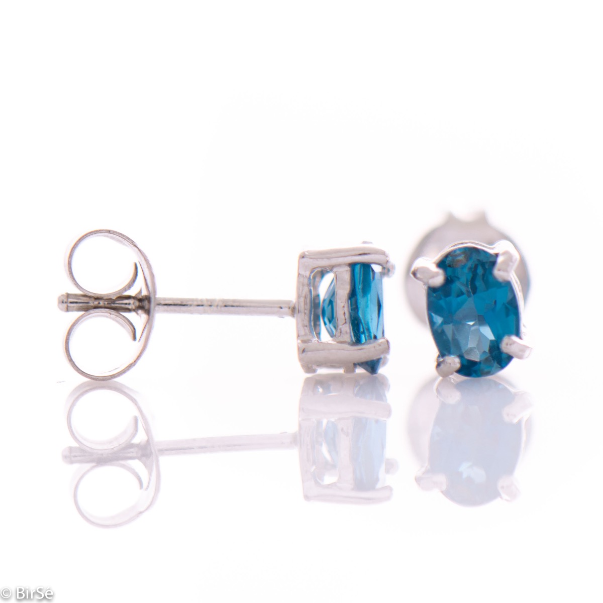 Delicate and radiant stud earrings in rhodium silver with a natural London topaz stone.