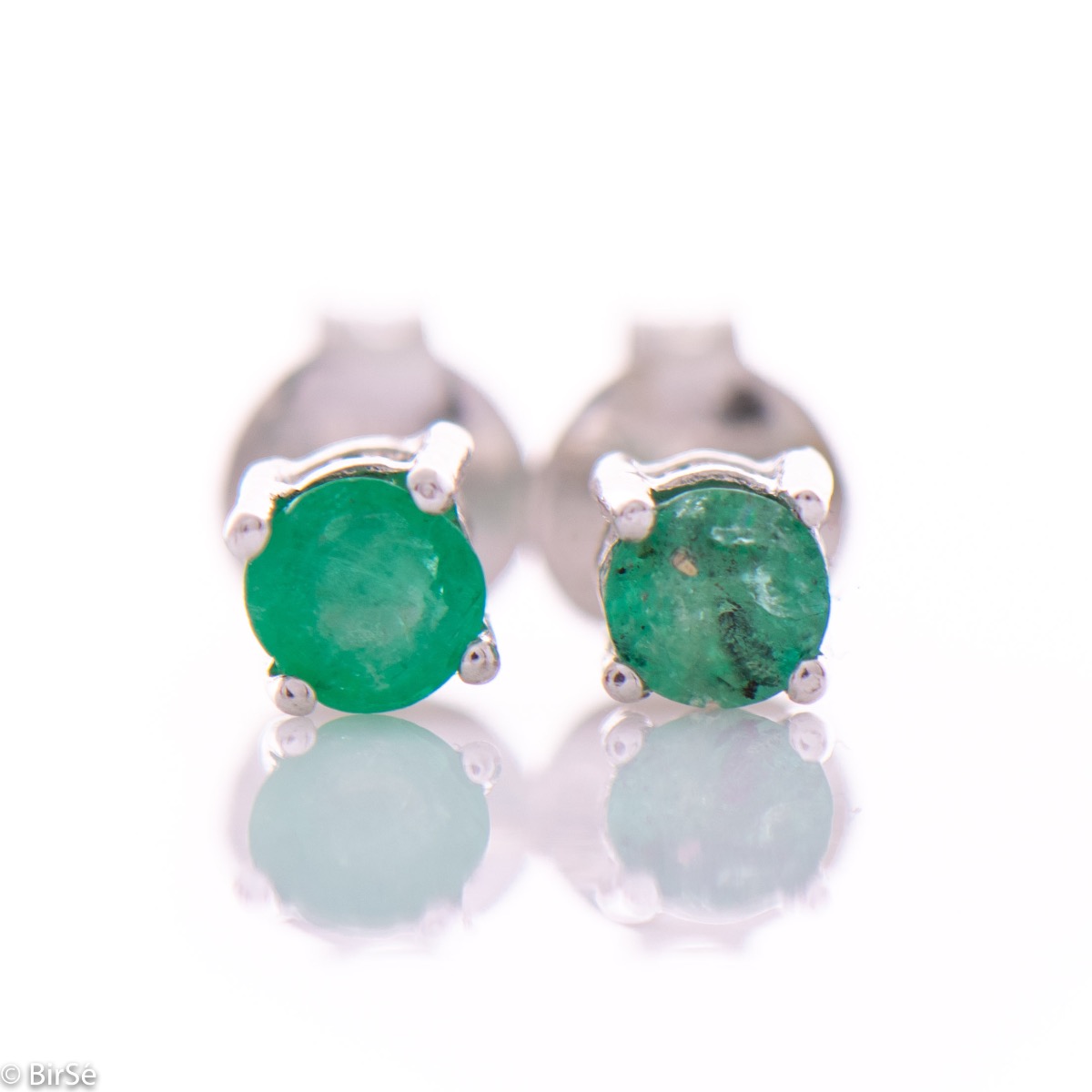 Modern and subtle stud earrings, delicately combining beautiful rhodium silver with a natural emerald stone.