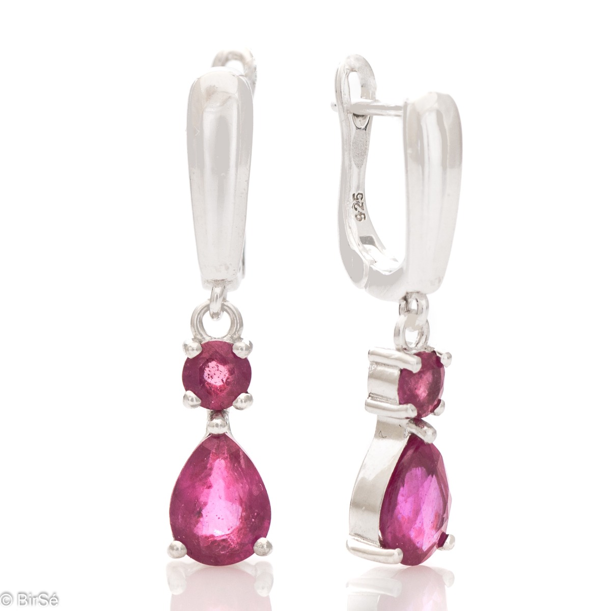 Fancy dangle earrings with English clasp. Finely cast silver and majestic natural drop-shaped ruby. Complete with a ring and pendant with the same elegant design.