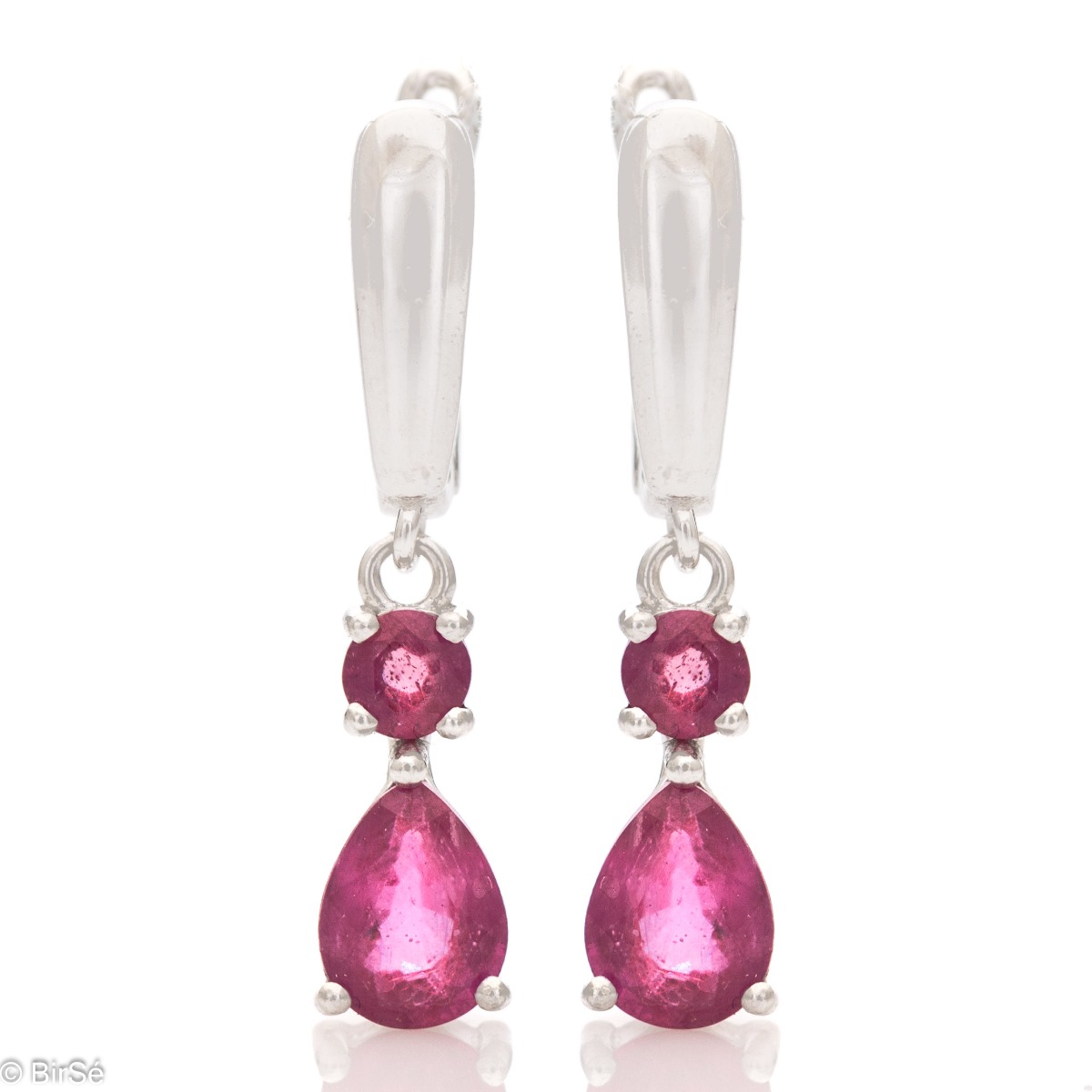 Fancy dangle earrings with English clasp. Finely cast silver and majestic natural drop-shaped ruby. Complete with a ring and pendant with the same elegant design.