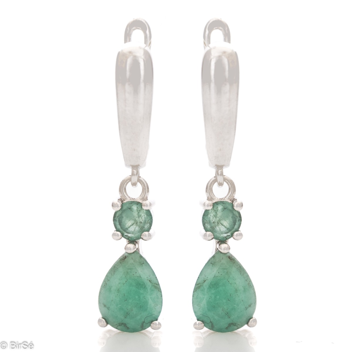 Fancy dangle earrings with English clasp. Finely cast silver and a majestic teardrop-shaped natural emerald. Complete with a ring and pendant with the same elegant design.