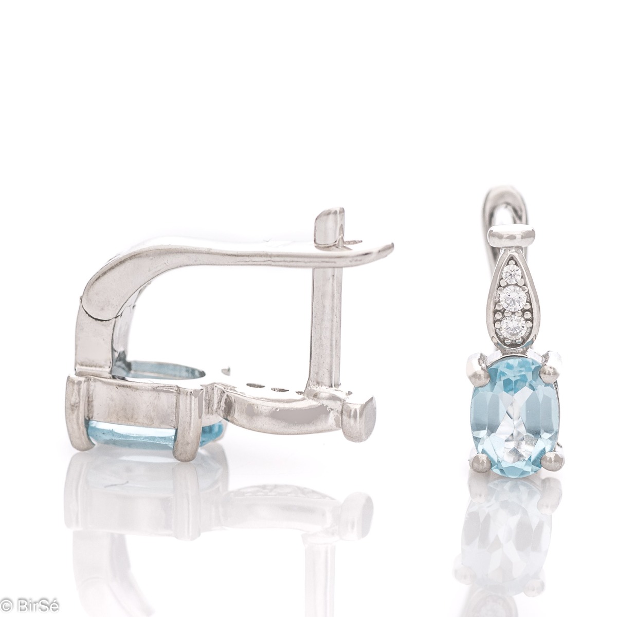 Dazzling women's earrings with English clasp and a delicate combination of radiant natural blue topaz, finely crafted in rhodium-plated silver, complemented by beautiful zircons.