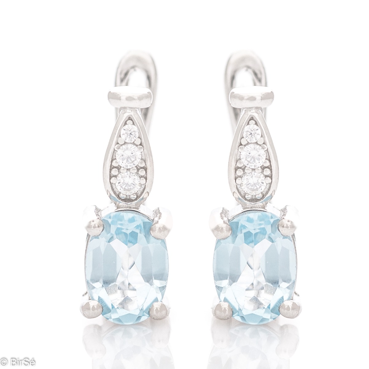 Dazzling women's earrings with English clasp and a delicate combination of radiant natural blue topaz, finely crafted in rhodium-plated silver, complemented by beautiful zircons.