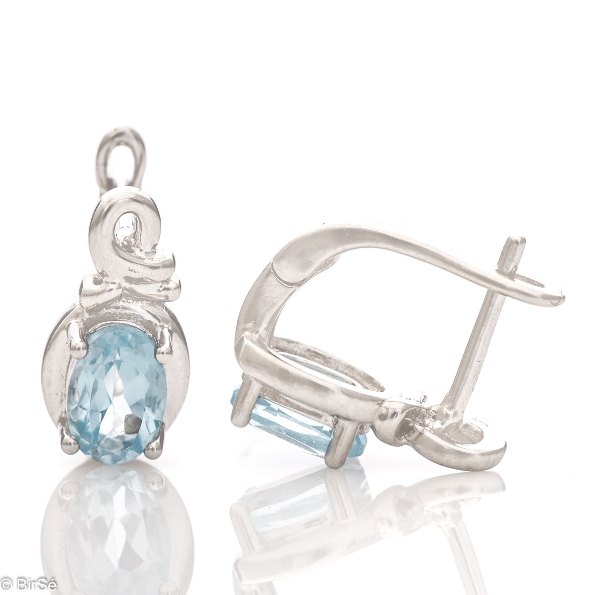 Exquisite ladies earrings with English clasp and delicate craftsmanship entirely of beautiful rhodium silver, complemented by a radiant natural blue topaz stone.