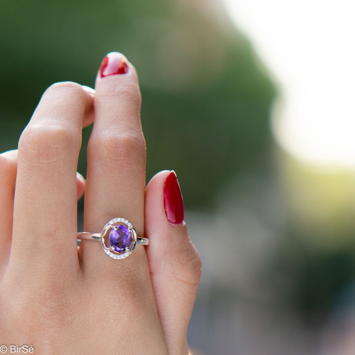 An elegant women's ring, shaped in oval elements and a gentle, beautiful look. Stylish craftsmanship from a fine combination of rhodium silver, zircons and natural amethyst. Complete with the same model of charming English clasp earrings.