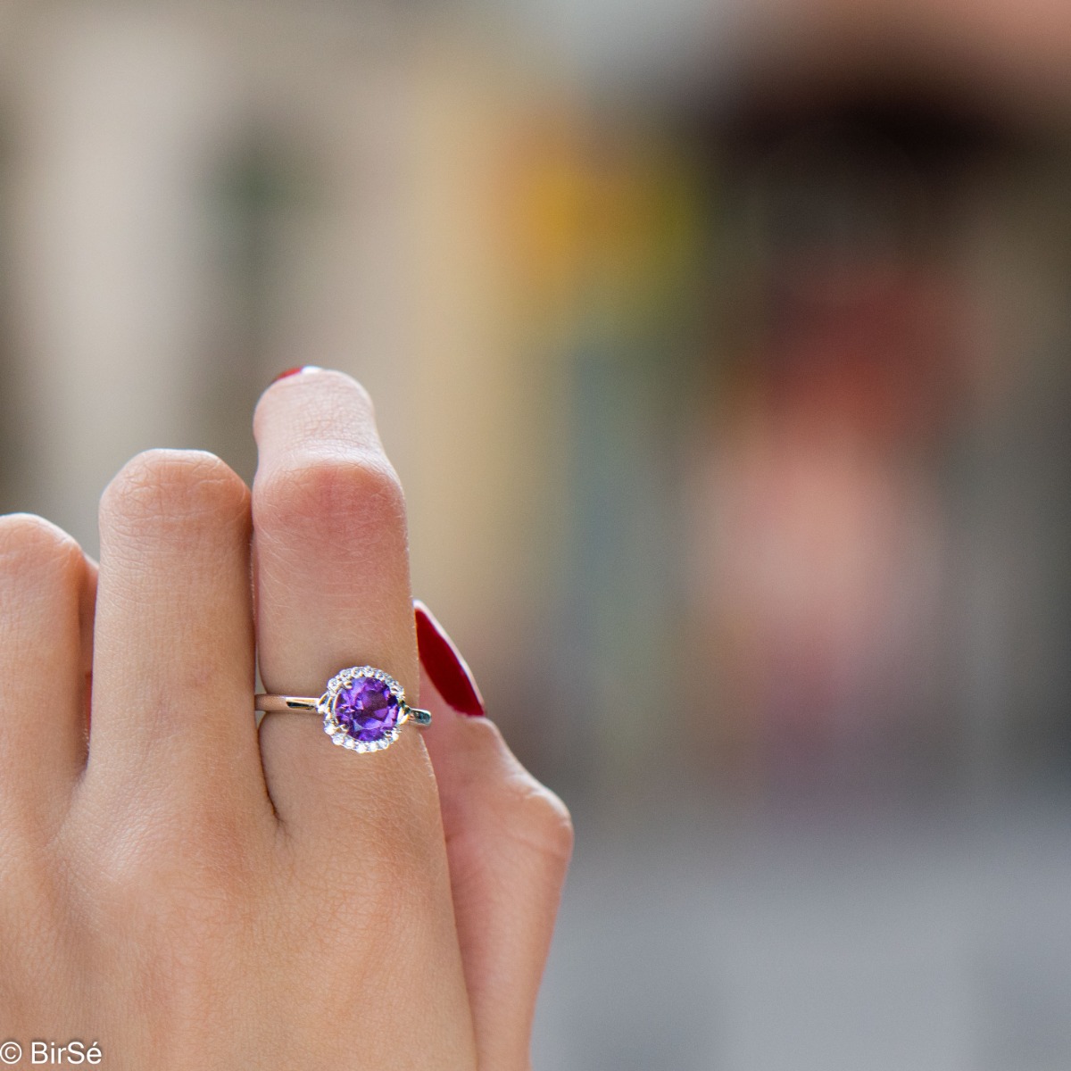 An elegant women's ring made of a delicate combination of rhodium-plated silver, natural amethyst and sparkling zircons. Part of a silver pendant and earring set from the same collection and the same striking design.