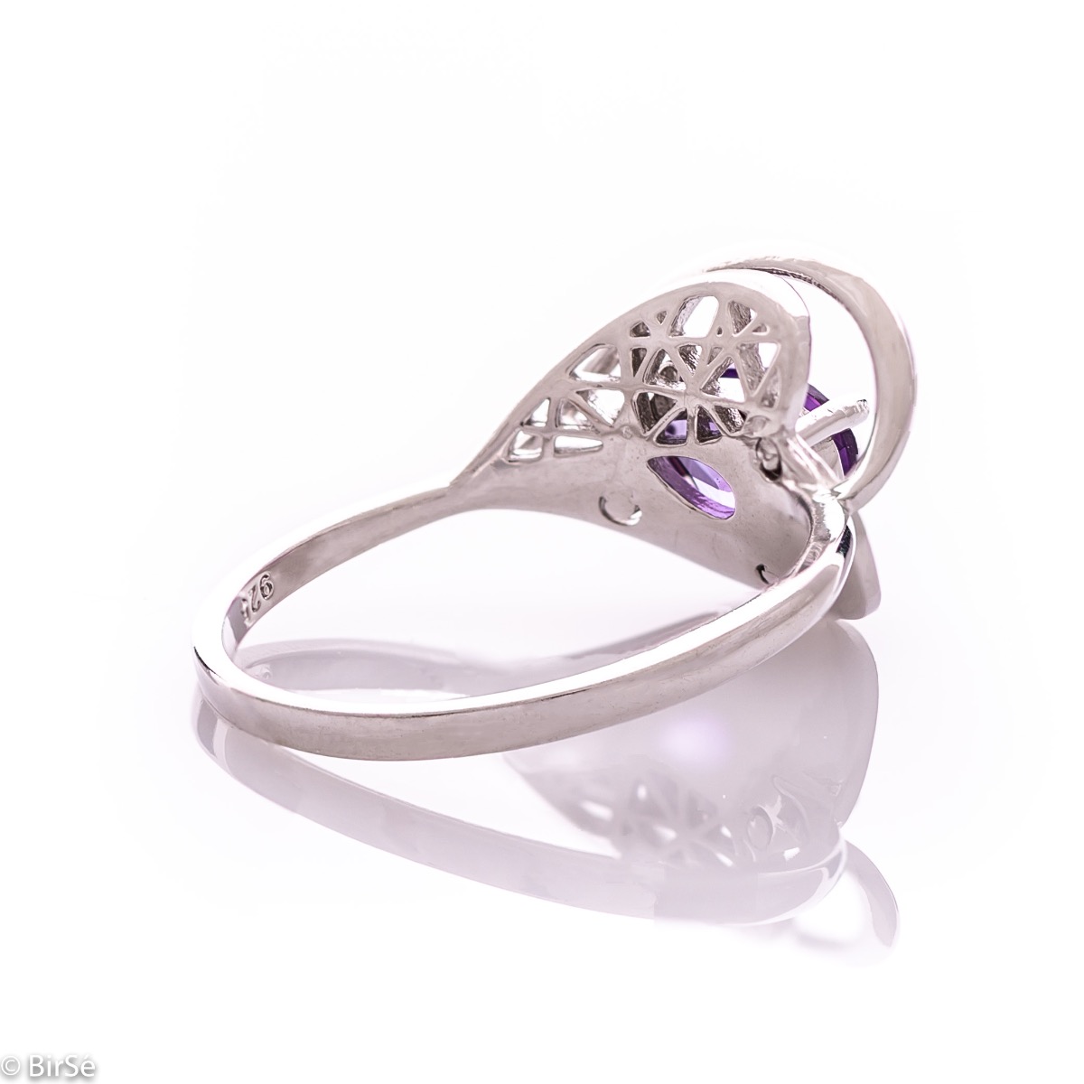 A spectacular women's ring with delicate workmanship entirely of rhodium-plated silver, resembling a heart intertwined with a radiant natural amethyst stone. It can be combined with a pendant and earrings of the same model.