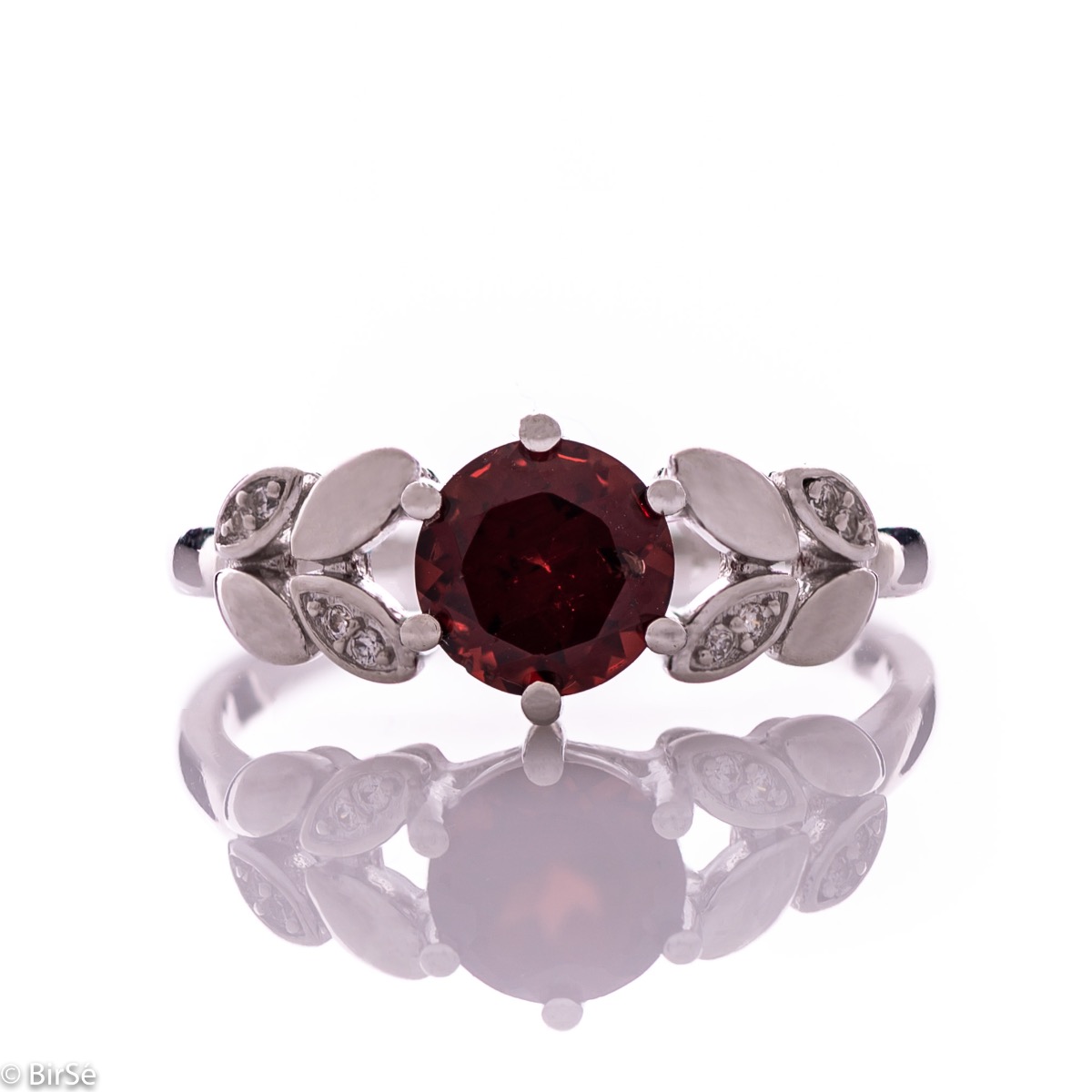 Elegant women's ring with delicate craftsmanship combining refined rhodium-plated silver with radiant natural garnet and petals of sparkling zircons. Can be combined with earrings and pendant of the same model.