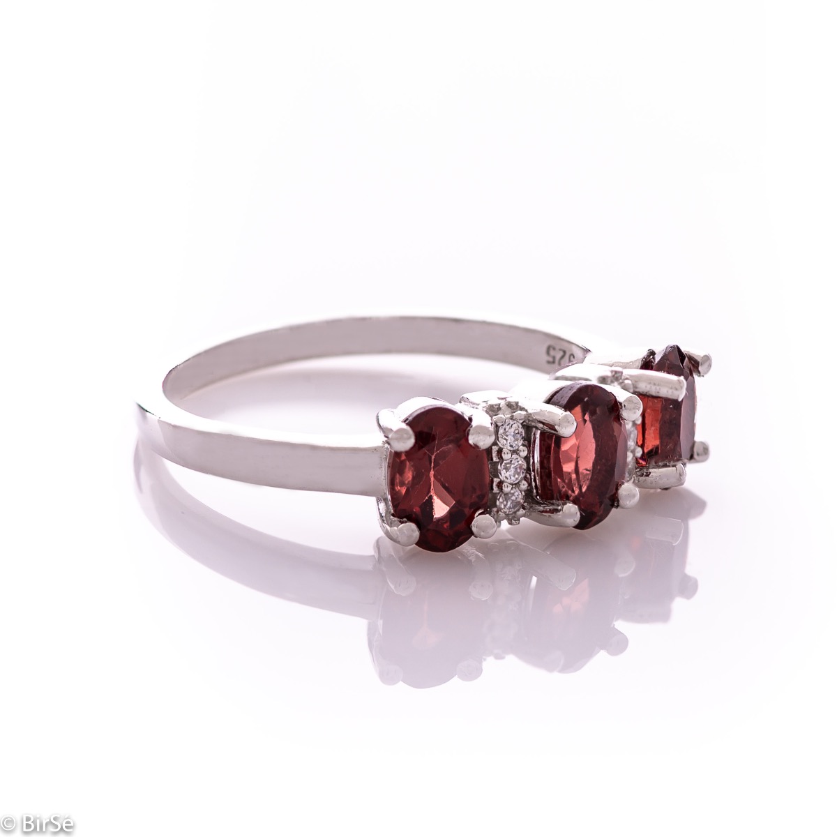 An elegant women's ring with delicate craftsmanship combining rhodium-plated silver with three radiant natural garnet stones and sparkling zircons.