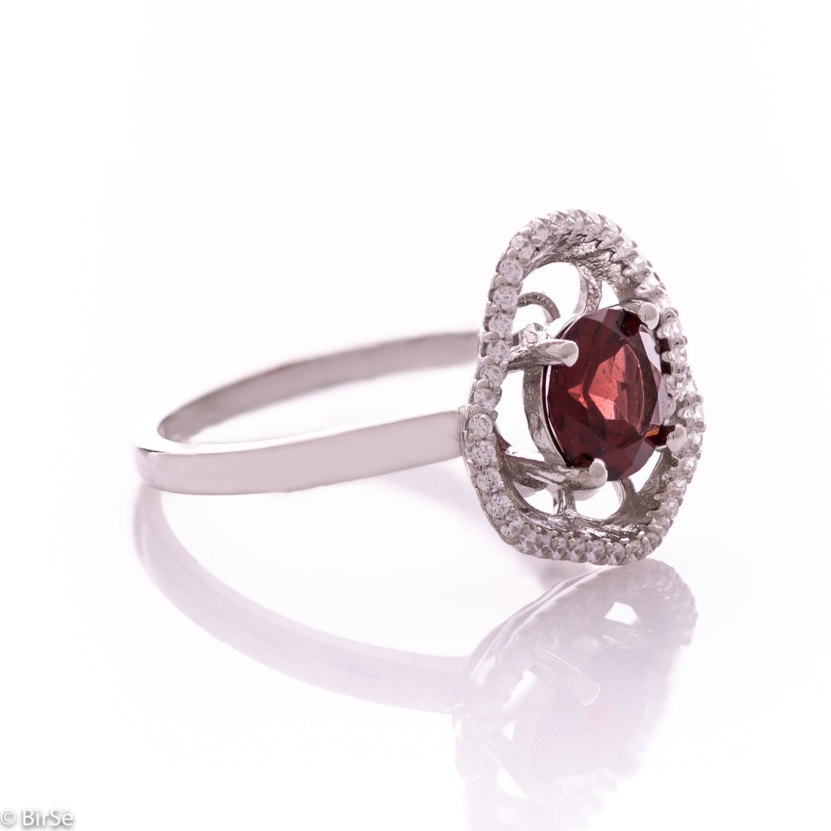 An exquisite women's ring with exceptional workmanship combining a radiant natural garnet with sparkling zircons and delicate rhodium-plated silver.