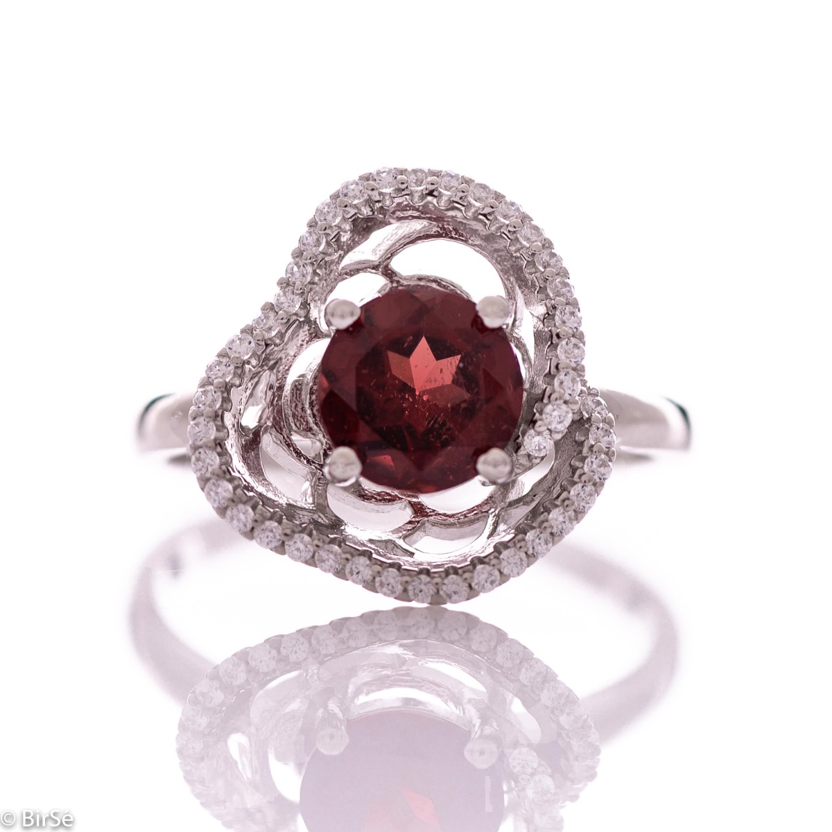 An exquisite women's ring with exceptional workmanship combining a radiant natural garnet with sparkling zircons and delicate rhodium-plated silver.