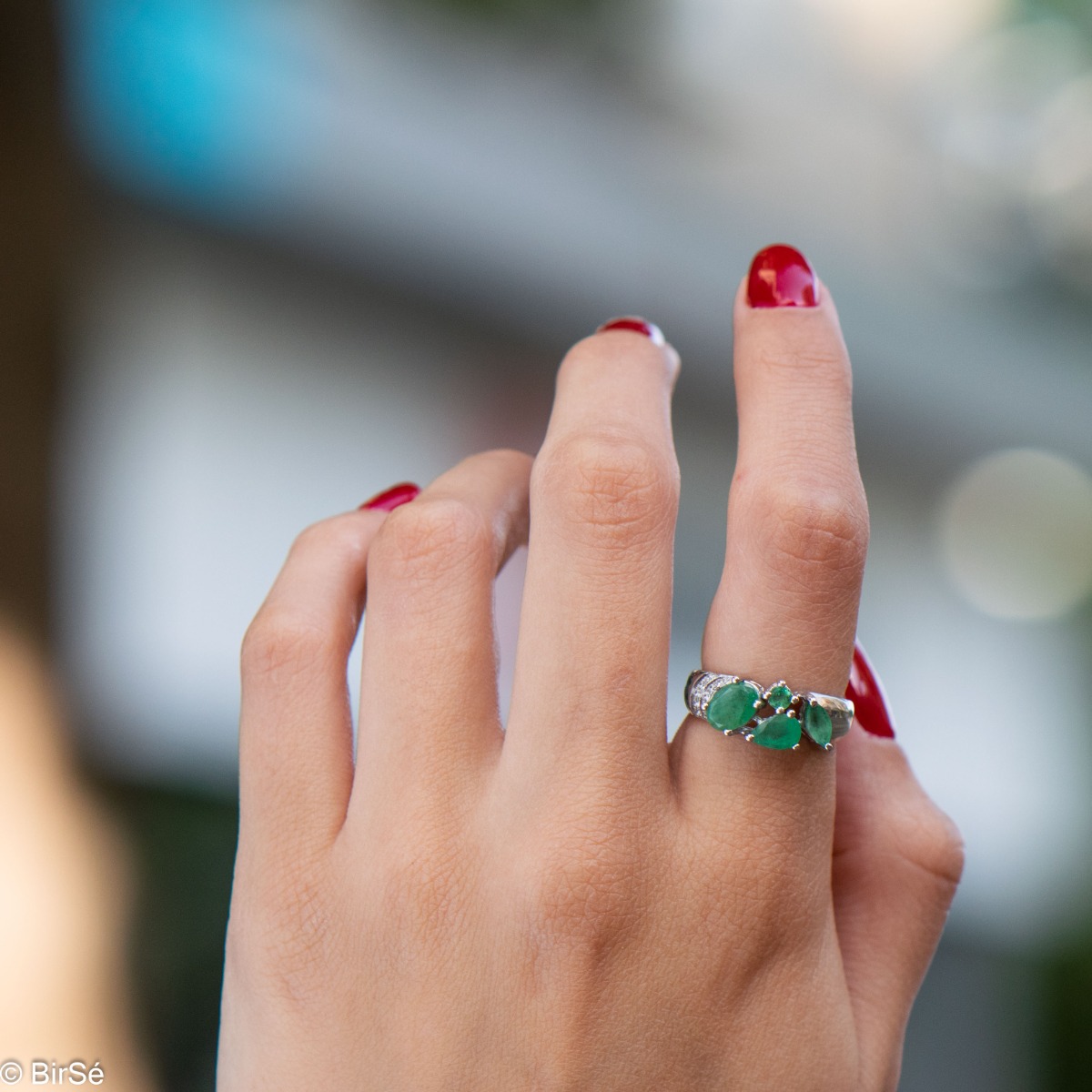 The captivating beauty of natural emeralds expressed in full force in a regal silver ring. The combination with sparkling zircons makes the jewelry even more charming.