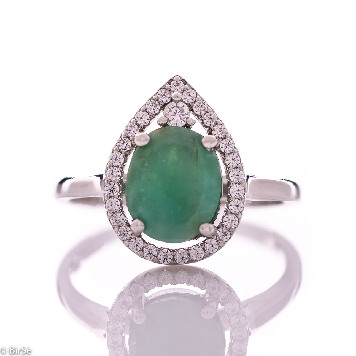 An elegant women's ring with spectacular craftsmanship combining refined rhodium-plated silver with a radiant natural emerald and sparkling zircons. Can be combined with earrings and pendant of the same model.