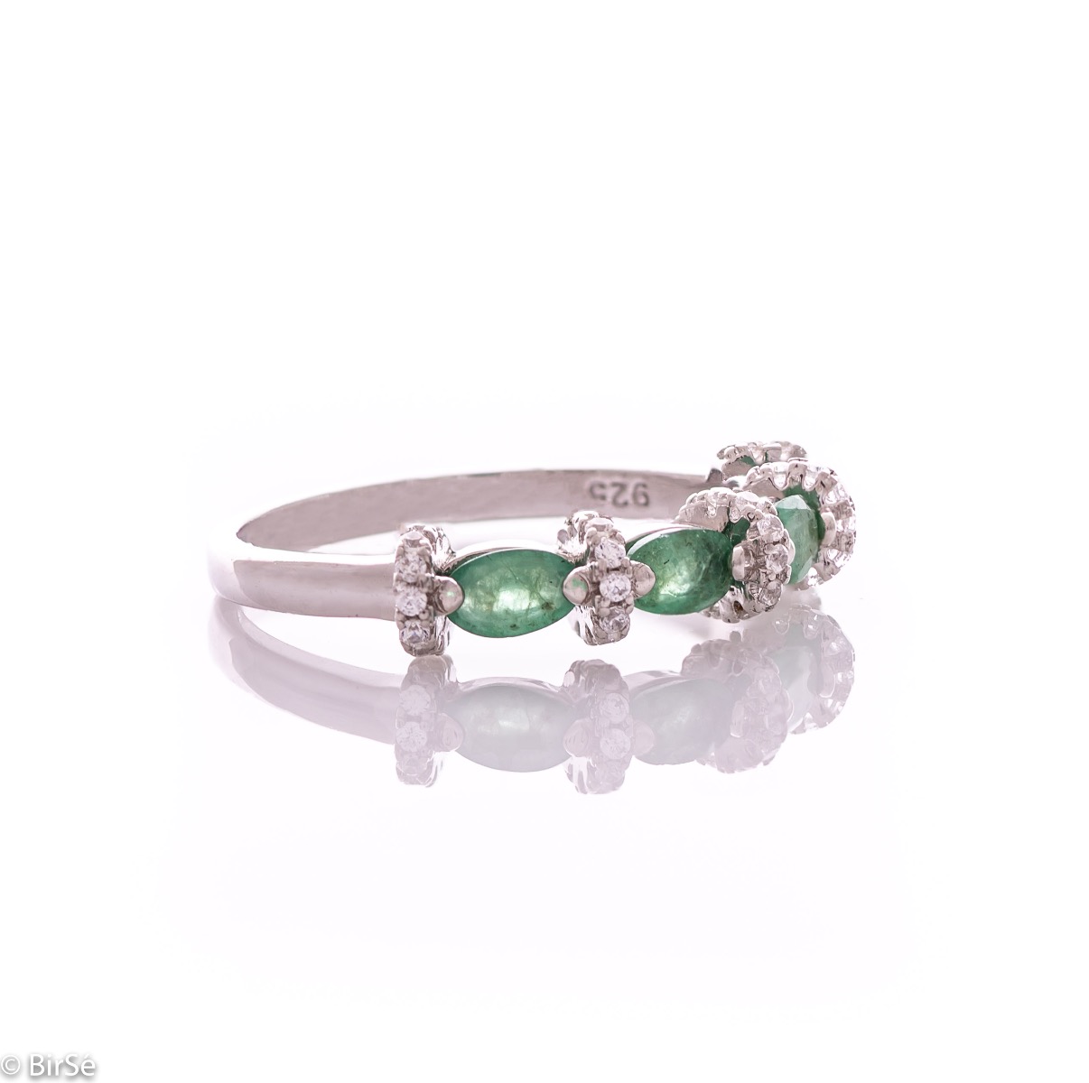 Delicate women's ring intertwining a radiant natural emerald with sparkling zircons and exquisite workmanship entirely in rhodium-plated silver.