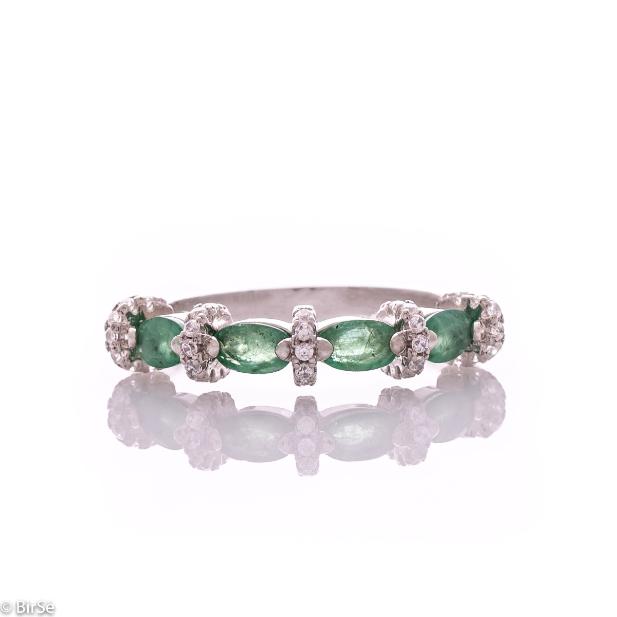 Delicate women's ring intertwining a radiant natural emerald with sparkling zircons and exquisite workmanship entirely in rhodium-plated silver.