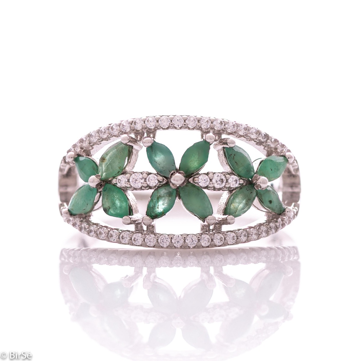 An elegant women's ring with a spectacular workmanship entirely of rhodium-plated silver, combined with delicate flowers of natural emerald and zircons. Can be combined with earrings and pendant of the same model.