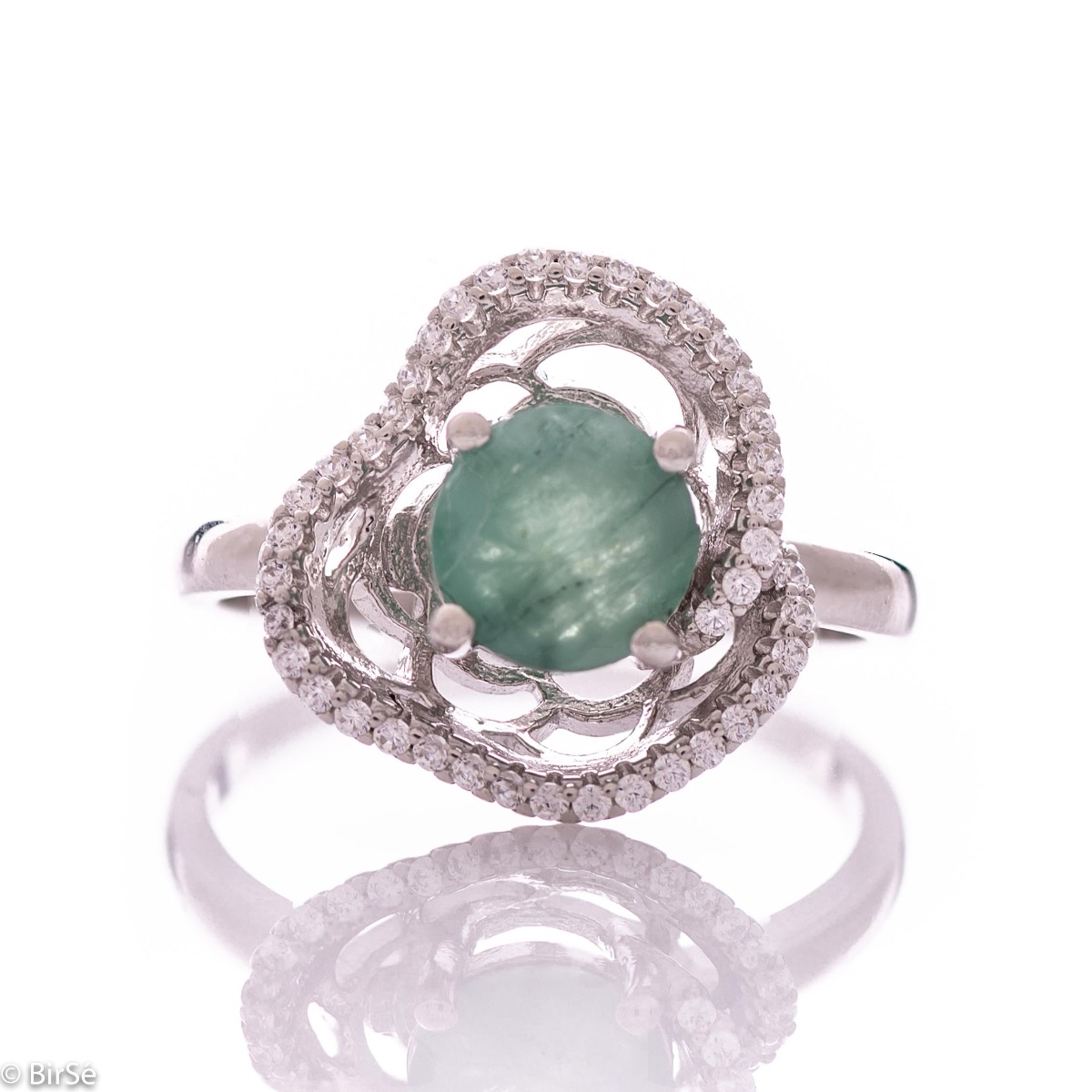 An exquisite women's ring with exceptional workmanship combining a radiant natural emerald with sparkling zircons and delicate rhodium silver. Can be combined with earrings and pendant of the same model.