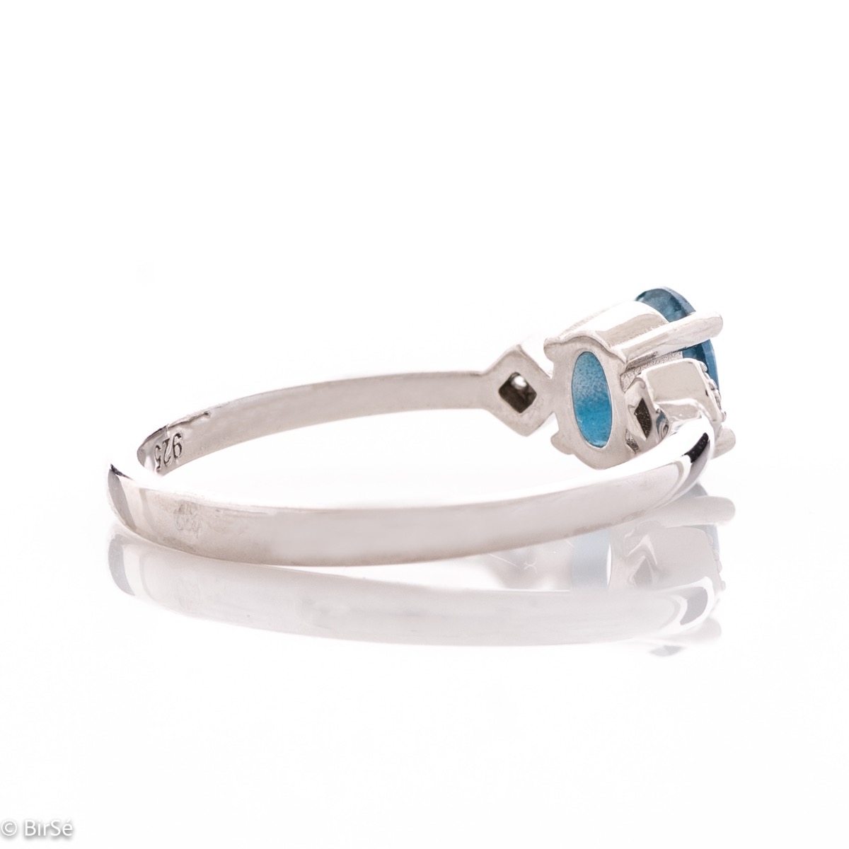 An exquisite women's ring with exceptional workmanship entirely of delicate rhodium silver, combined with a radiant natural stone London topaz and sparkling zircons. It can be combined with earrings and a delicate pendant.