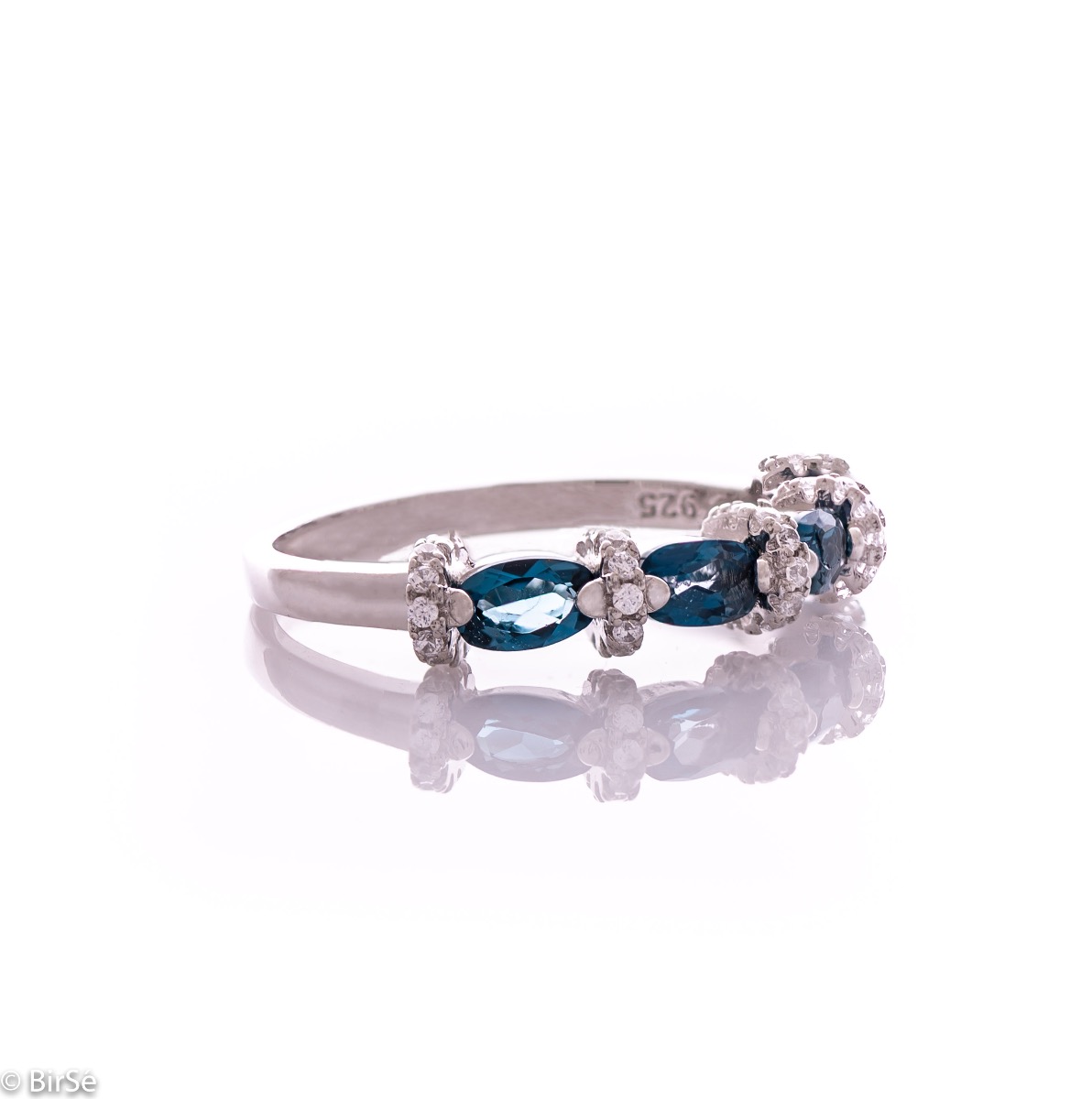 Delicate women's ring interweaving radiant natural London topaz with sparkling zircons and exquisite workmanship entirely in rhodium-plated silver.