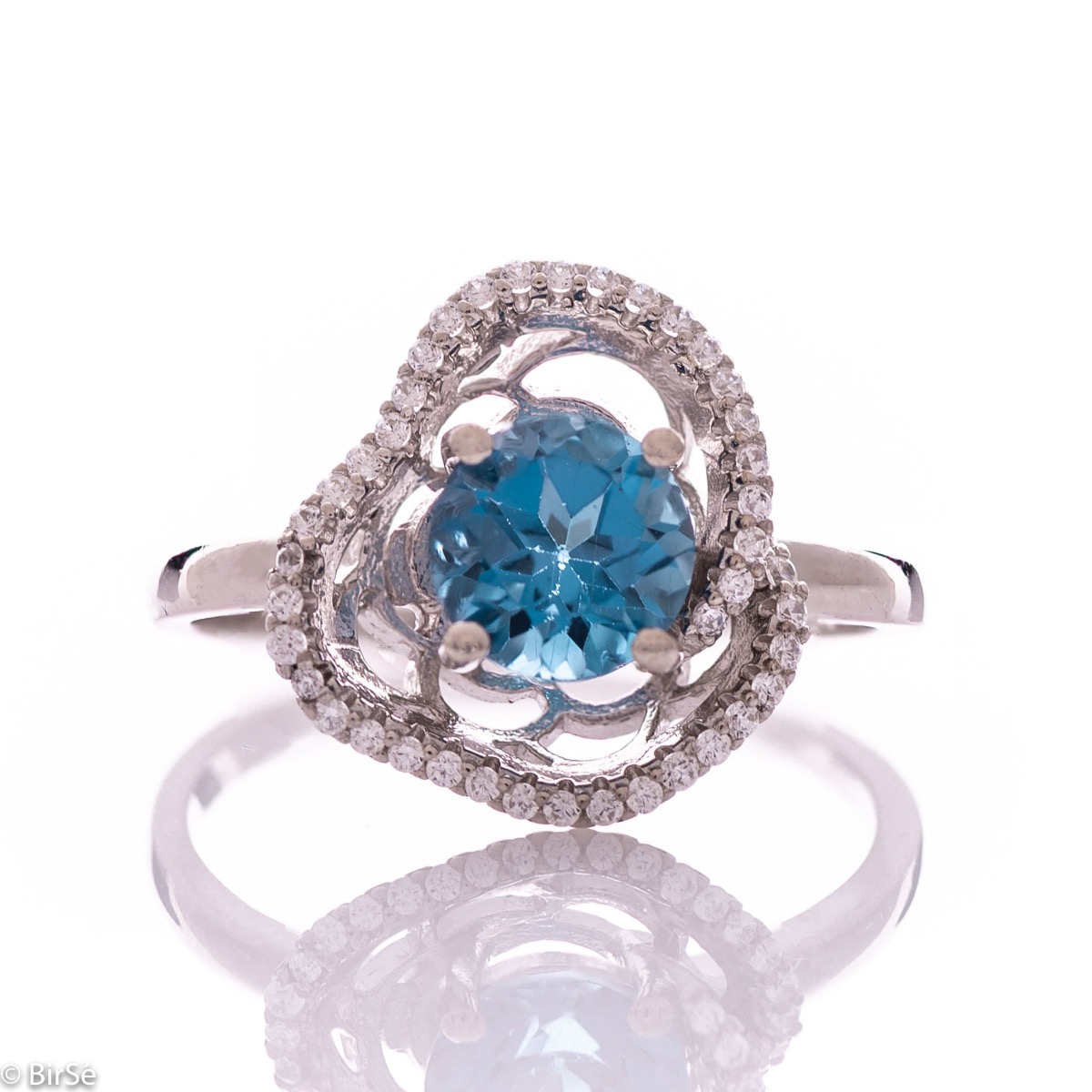 An exquisite women's ring with exceptional craftsmanship combining radiant natural London topaz with sparkling zircons and delicate rhodium silver. Can be combined with earrings and pendant of the same model.