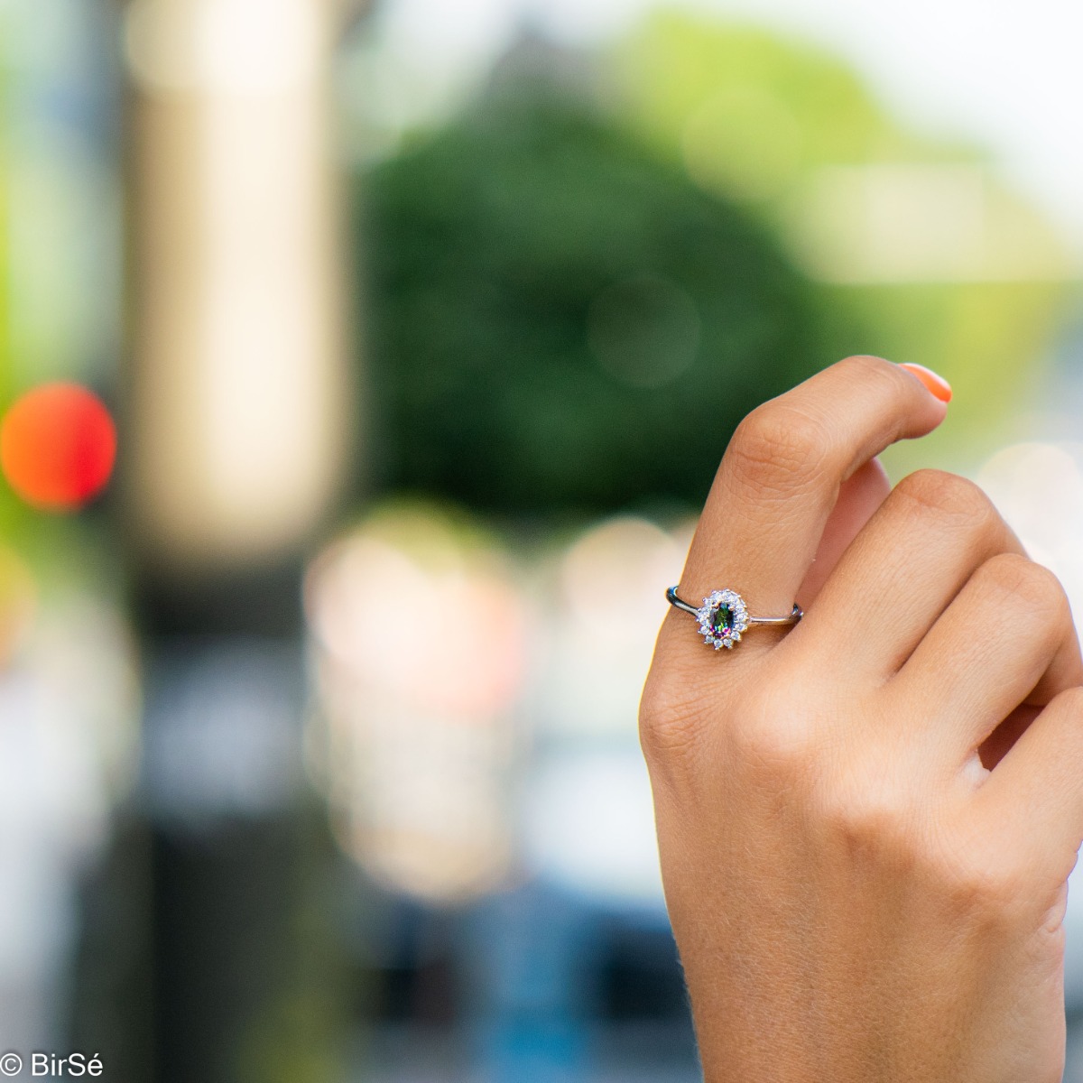 An elegant ladies' marquise ring with a unique and delicate design, combining a radiant natural stone, mystic topaz, surrounded by sparkling zircons and elegant rhodium-plated silver.