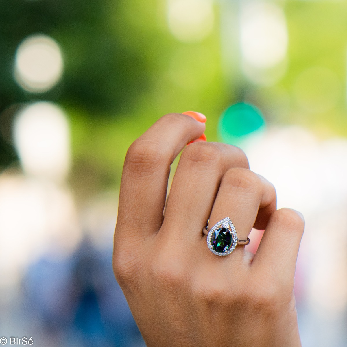 A spectacular and elegant ring interweaving multi-colored mystic topaz with a shell of sparkling zircons and beautiful craftsmanship entirely in rhodium-plated silver.