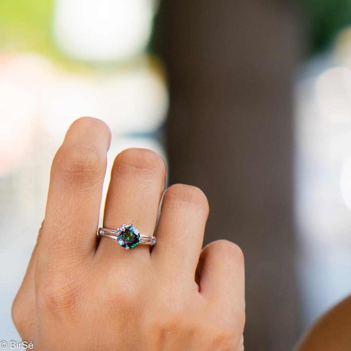 A spectacular women's ring with delicate detailing, combining a multi-colored and radiant natural stone, mystic topaz, with beautiful rhodium-plated silver.