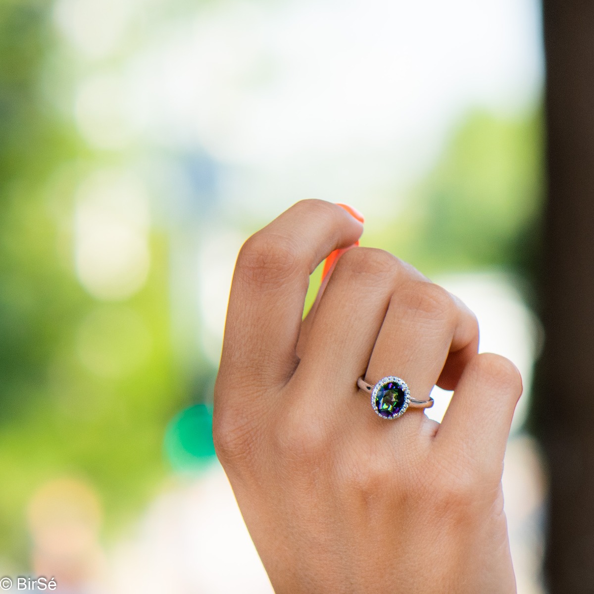 Exquisitely crafted entirely from soft rhodium silver with a stylish and simple design, combining a radiant natural mystic topaz surrounded by sparkling zircons - our new exclusive ladies' ring.