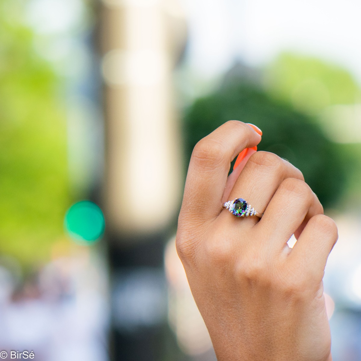 An elegant women's ring with precision craftsmanship entirely of shiny rhodium silver and a spectacular pineapple shape of natural mystic topaz stone with zircons.